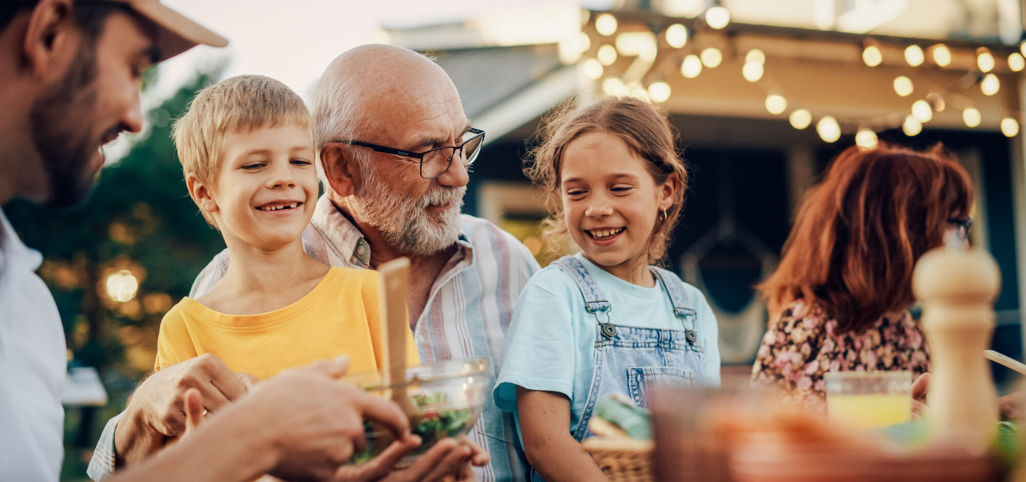 Happy Senior Grandfather Having Fun With His Grandchildren
